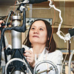 Catherine Hui Niu makes adjustments on an adsorption column, which is capable of treating water and particularly useful for gas-phase separation. | William DeKay photo