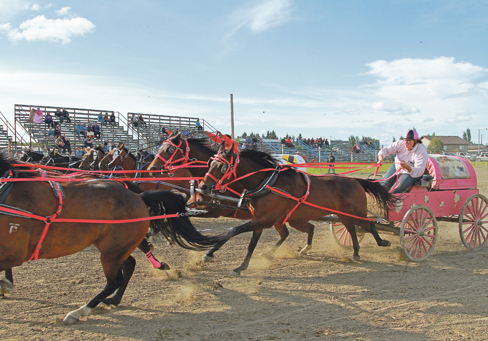 Amber L’Heureux comes out of the barrels with her chuck wagon team during a race in St. Walburg, Sask., in 2014.  | Just Enjoy Photography/Carrie Arlett photo