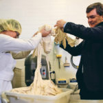 Alberta Agriculture Minister Oneil Carlier helped Skeena Ngo transfer dough to a mixer during a visit to Crust Craft last January. The minister said 2018 didn’t start off so well but managed to improve by the end. | File photo