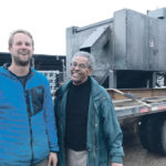 Darren Haarsma, left, and Tam Tekle of Natural Fibre Technologies stand in front of their company’s mobile hemp and flax decorticator. | Photo supplied by Jesse Hahn