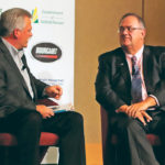 Tom Schwarz, right, talks to Kevin Hursh about farmers’ rights to repair their farm equipment, which Schwarz said is becoming an increasingly important issue. | Robin Booker photo