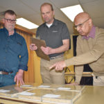 Surya Acharya, right, points to one of the pedigreed seed samples that he, Brian Tamminga, left, and Rick Czarny were judging Feb. 20 for the 122nd annual North American Seed Fair. Results will be on display Feb. 27-March 1 at Ag Expo in Lethbridge. | Barb Glen photo