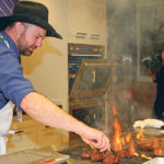 Musician Kent Nixon turns steaks during the Feed a Farmer celebrity cook-off held in Calgary to celebrate national agriculture day. Four teams were asked to use beef, pulses and dairy to create a made-in-Alberta meal that was judged by local farmers and ranchers. | Barbara Duckworth photo