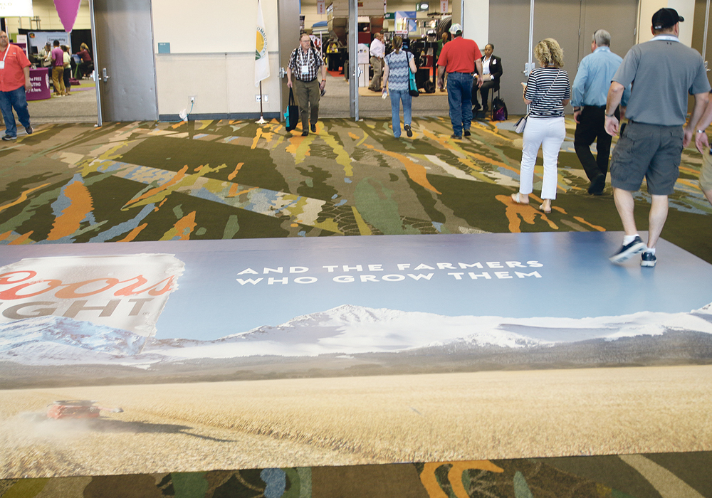 Farmers attending the recent 2019 Commodity Classic, including U.S. Agriculture Secretary Sonny Perdue, vowed to stop drinking Bud Light beer after it aired a Super Bowl commercial that said it is no longer using corn syrup in its beer. That prompted Coors Light to take out a carpet advertisement in front of the trade show doors at the Commodity Classic saying, “we’re proud of our ingredients and the farmers who grow them.”  |  Sean Pratt photo