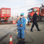 A worker disinfects a vehicle March 9 near a farm where African swine fever was detected in Yulin, China. The hog disease is widespread in that country, and Ottawa is taking steps to ensure it does not spread to Canada. | Reuters photo