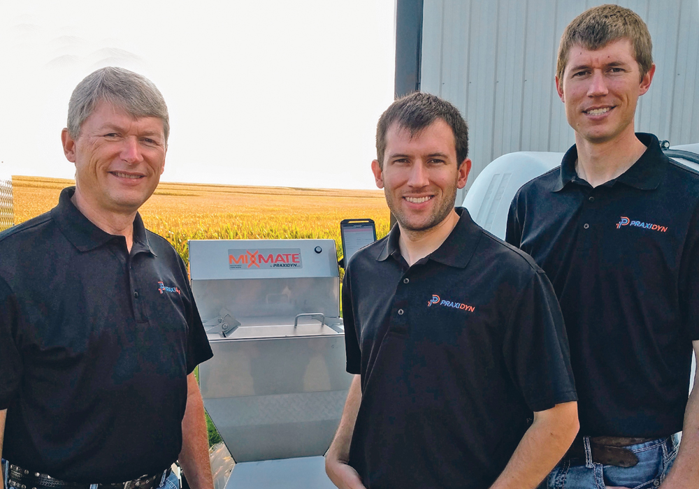 Praxidyn founder Doug Applegate with sons Luke, at left, and Brent focus their energy on developing products like their Mixmate Pro Inductor, in the background, to help streamline the process of filling sprayers.  |  Doug Applegate photo
