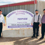 Mark, left, Phillip and Jerry Wipf take biosecurity seriously in the hog barns at Lakeside Colony near Cranford, Alta.  |  Submitted photo