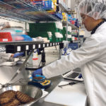 Impossible Foods product development associate scientist Kyle Okada measures plant-based burgers tailor-made for Burger King at a facility in Redwood City, California. | REUTERS/Jane Lanhee Lee photo