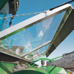 The adjustable angle of the solid margard panels allow them to match the angle of the windscreen fingers, thus creating a vacuum effect that sucks canola seeds into the feeder house. | Ron Lyseng photo