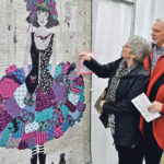 Cecily Burwash, left, a quilter from Rocky Mountain House, Alta., and her friends, Greig and Colleen Sankey from Calgary, admire Moondust & Midnight by Tracey Brittain. | Maria Johnson photo