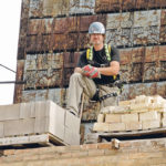 Using historic brick and concrete blocks, Kurt MacPherson begins repairs on the outside wall of the Grand Theatre in Indian Head, Sask. | Bruce Neill photo