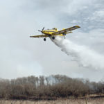 A spray plane operating as part of the provincial SEAT (single engine air tanker) program drops water on a fire southwest of Biggar, Sask., April 23. The Saskatchewan government developed the program last year to train aerial applicators how to use their airplanes to dump water on fires. The extent of last week’s blaze was an indication of how dry it has been in many parts of the Prairies this spring. | Paul Yanko photo