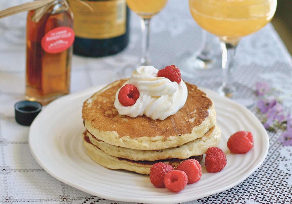 Serve lemon ricotta pancakes with whipped cream and maple syrup. A mimosa is a special touch. The drink is called mimosa because the bright colour resembles the blooming mimosa tree, the symbol of the Mediterranean spring.  |  Sarah Galvin photo