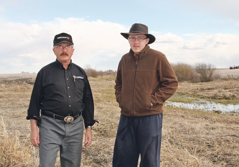 Peter Onofreychuk and his son, Mark, on their farmland near MacNutt, Sask. The Blackbird Creek has at times flooded surrounding land due to agricultural drainage upstream. | Karen Briere photo