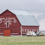 Visitors make their way to the barn to look and shop. A much needed rain earlier in the day made the dirt road too muddy for travel. | Sandy Black photo