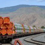 Steel pipe to be used in the oil pipeline construction of Canada's Trans Mountain Expansion Project sit on rail cars at a stockpile site in Kamloops, B.C. | REUTERS/Dennis Owen photo