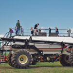 Students enjoy the opportunity to climb on large farm equipment. | Barb Glen photo