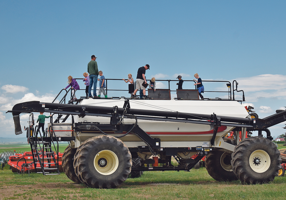 Students enjoy the opportunity to climb on large farm equipment. | Barb Glen photo