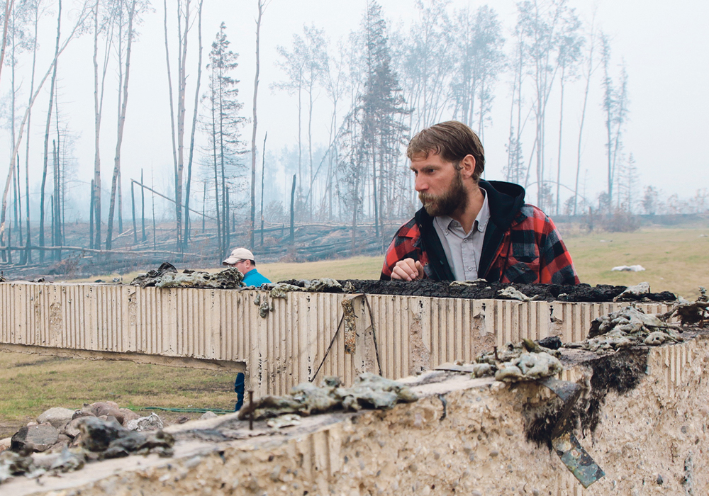 Mackenzie County Reeve Josh Knelsen inspects a home destroyed by the fire in the La Crete area.  |  Jeremy Simes photo