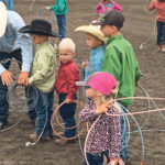 Shane Brown helps his son, Slone, with his loop during the dummy roping event at last year’s event while Slone’s brother, Brock, and cousins Kesler and Carter Brown wait their turn. Sister Dally in the foreground. | Kelly McIntyre photo