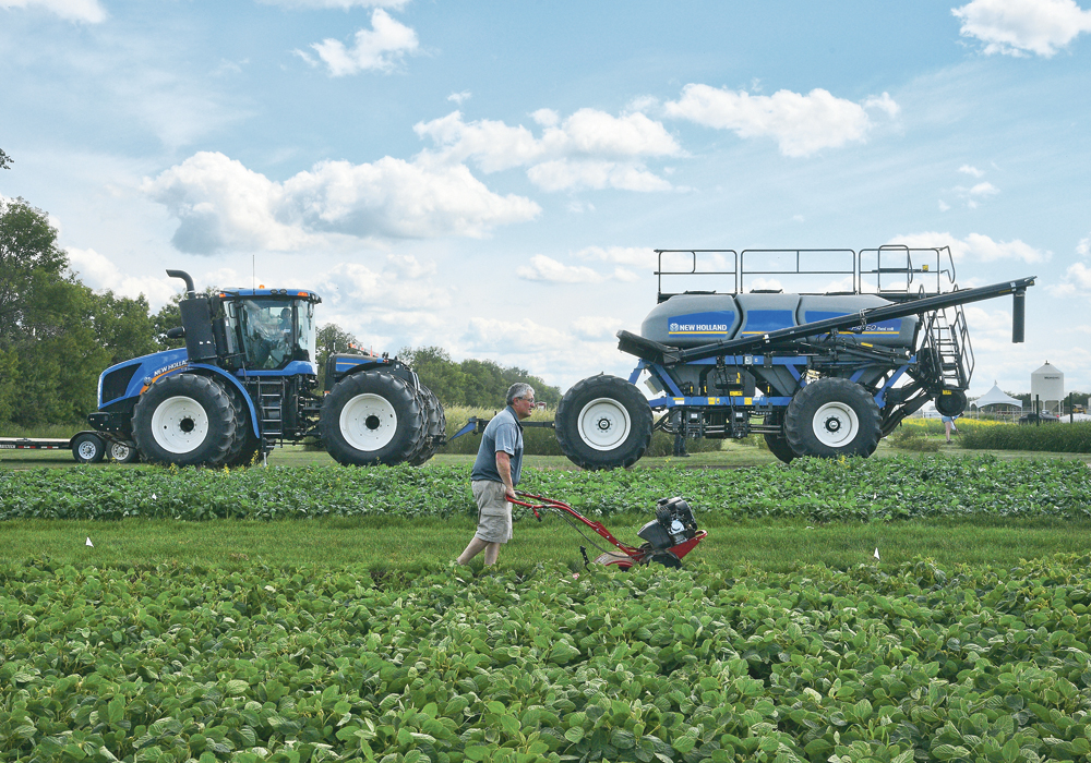 Rene Mabon, agronomy manager for BrettYoung rototills around their plot of soybeans as some of the bigger equipment arrives at Ag in Motion, July 9.  |  William DeKay photo