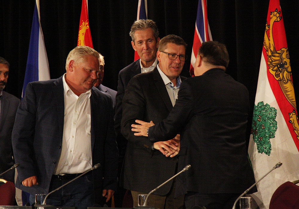 At right, Quebec premier Francois Legault shakes hands with Saskatchewan premier Scott Moe at the conclusion of the Council of the Federation premiers' meeting in Saskatoon as Ontario's Doug Ford and Manitoba's Jim Pallister look on. | KAREN BRIERE PHOTO
