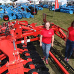 Olena Peleshok, left, and Victoriia Shebanova of Lozova Machinery in Ukraine show off their Ducat compact disc harrow at the Ag in Motion farm show in Langham, Sask. | Michael Raine photo