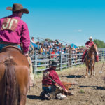 John and Rob Palmer handle the roping while John Esser waits for Riley Esser with the chalk-covered branding iron. | Mike Sturk photo