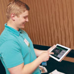 Kyle Koshalek, a research co-ordinator associate with the National Farm Medicine Center, shows new online tools that can help farmers reduce hazards on their farms. | Jeremy Simes photo