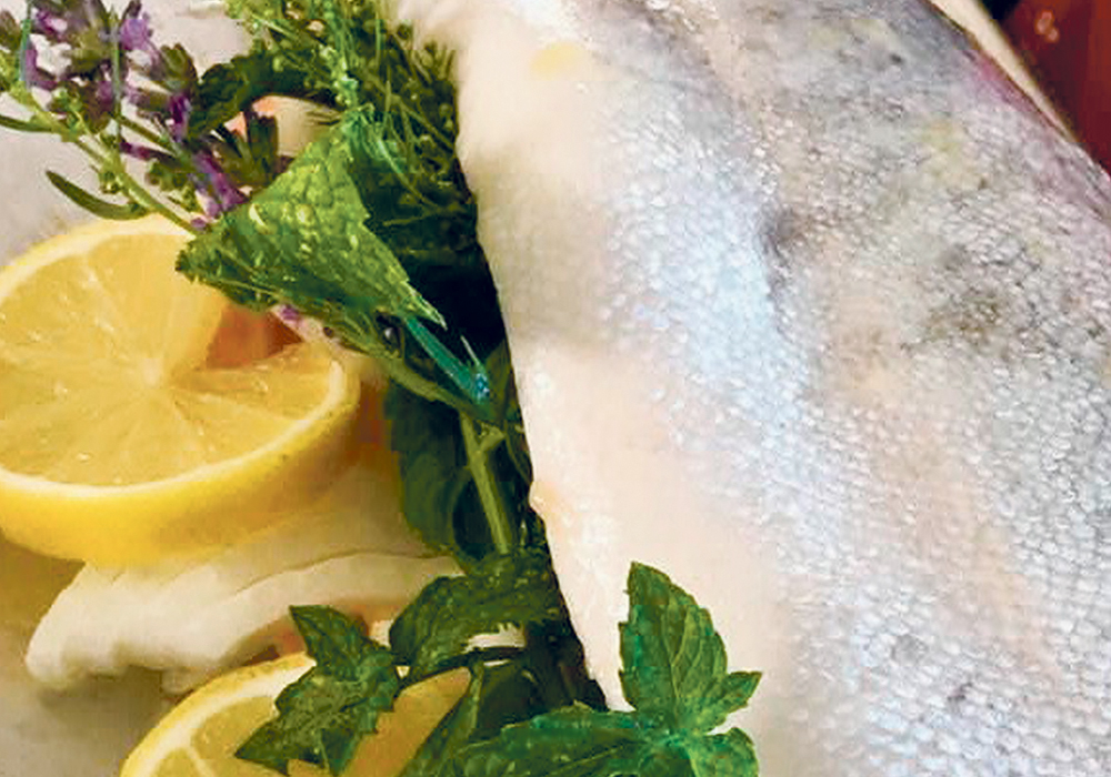 Use a variety of herbs from those on hand. Lavender, oregano, thyme and mint from the garden work well. Stuff the fish and tie with butcher’s string to hold it all together.  |  Sarah Glavin photo