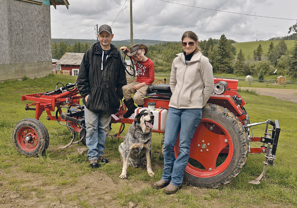 Steve, left, Max and Nicky Breum operate Gone Green Farms in a long, lush valley near Westerose, Alta., where Steve’s family has lived since the early 1930s. The couple appreciates the versatility, manoeuvrability, and affordability of this Oggun tractor, which they bought last year. It has helped manage their five acres of market garden. They like the fact that parts are available off the shelf at farm supply stores, auto parts retailers and online.  |  Maria Johnson photo