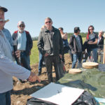 Noel St Jean of the Agroforestry and Woodlot Extension Society shows the different kinds of mulch that may be used to protect tree seedlings when they are first planted in a shelter belt. The covers keep out weeds and hold moisture. | Barbara Duckworth photo