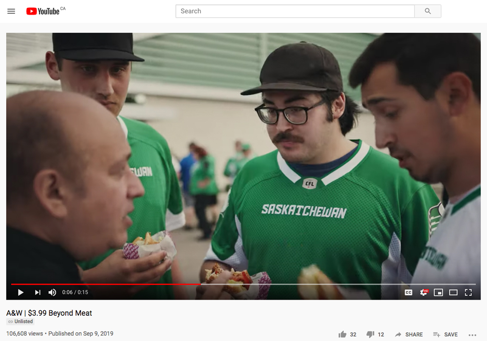 An A&W ad currently running shows people wearing Rider gear trying the restaurant's meatless Beyond Meat burgers outside Regina's Mosaic Stadium. | Screencap via YouTube/A&W Canada