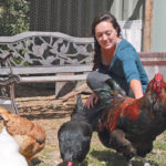 Katy Peck visits with the chickens on her farm near Charlie Lake, B.C. | Jeremy Simes photo