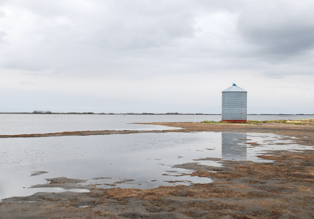 An abandoned grain bin sits on the shores of the Quill Lakes near Dafoe, Sask. Water levels have been rising for the past decade and have flooded more than 90,000 acres of cropland and pastureland since 2005.  |  Brian Cross photo