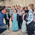 Alberta Justice Minister Doug Schweitzer visits with children at the Jumbo Valley Hutterite Colony near Granum, Alta., Oct. 3. He and Premier Jason Kenney and Agriculture Minister Devin Dreeshen visited the colony to announce plans to stiffen penalties for people who trespass and invade farms. The colony’s turkey operation was invaded by activists on Sept. 2. | Barb Glen photo
