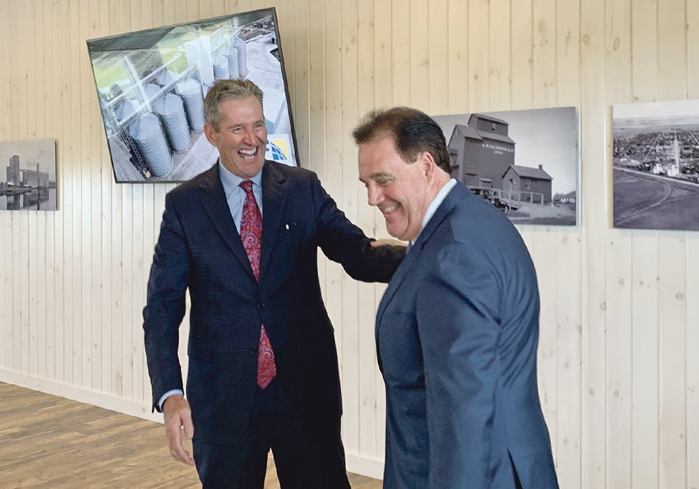 Manitoba Premier Brian Pallister, left, and Paterson GlobalFoods President Andrew Paterson celebrate the announcement of the company’s $94 million oats processing plant.  |  Ed White photo