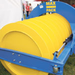 The side-shift hydraulic cylinder allows the tractor driver to shift the packer three feet left or right for safer packing along the edges of a bunker. The largest Max Pack is 13 feet wide and weighs 10,000 pounds when filled with water. The rollers at the two corners allow the packer to work right up against the bunker wall without causing damage to the bunker or the packing equipment. | Ron Lyseng photo