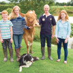 Katharine and Jason Salisbury farm in England with their children, James and Emily. Also in the photo is Edd the sheepdog and one of their pedigree Guernsey cows. | Salisbury family photo