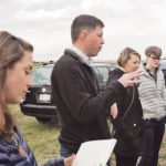 Jamie Larsen speaks to artists in the field. | University of Lethbridge photo