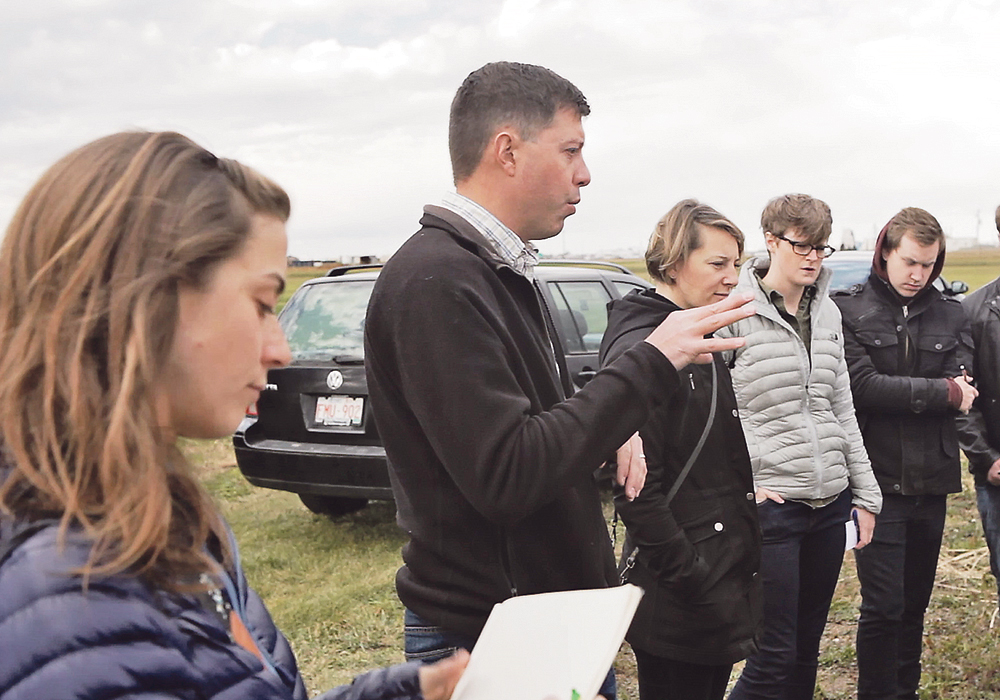 Jamie Larsen speaks to artists in the field.  |  University of Lethbridge photo