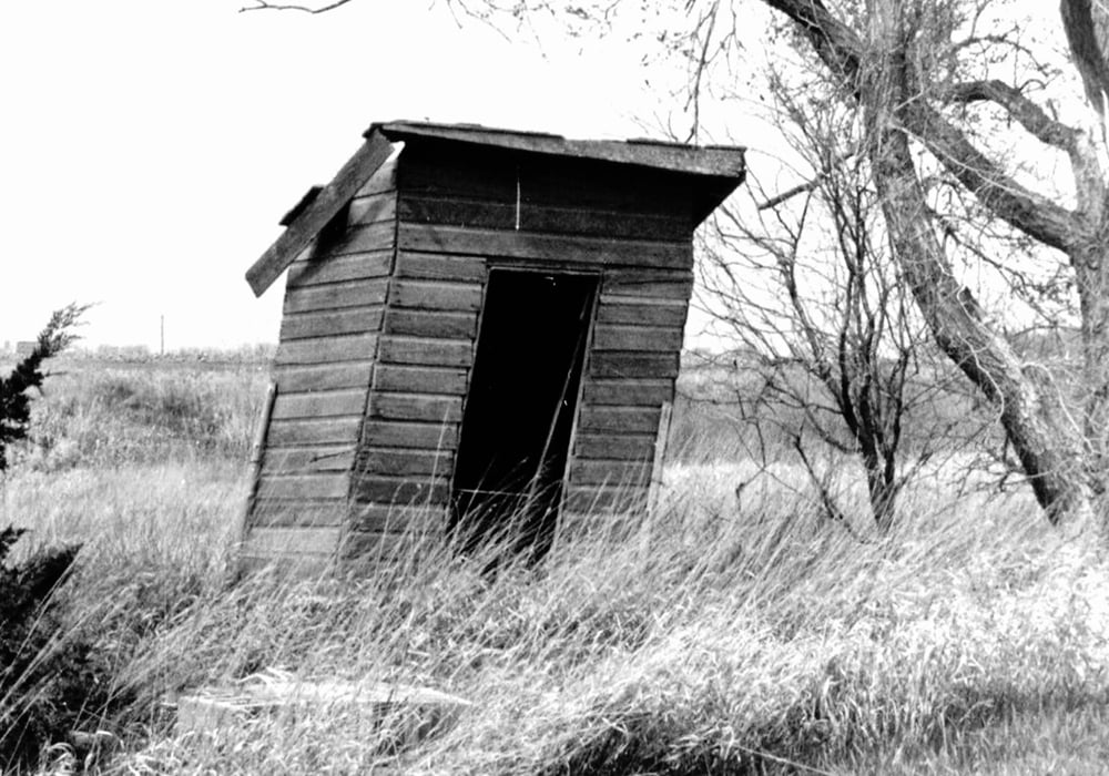 The outhouse underwent remodeling as time marched on with the shanty style giving way to a peak roof and the half-moon in the door becoming diamond-shaped.  |  Alma Barkman photo