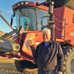 Mark Kihn holds a ripped cap that was caught by the wind and went through the combine. | Supplied photo