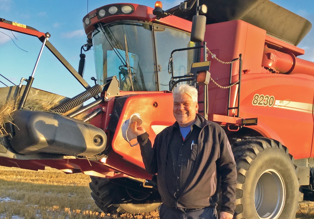 Mark Kihn holds a ripped cap that was caught by the wind and went through the combine.  |  Supplied photo