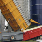The DumpDek serves as an intermediate stage between the forage trucks and the silo. It allows the driver to dump his load immediately when he gets to the silo. There’s no waiting. Then he takes off right away to get back to the field for more, while the DumpDek deals with the load, blowing it either into the silo or a forage bag. | Ron Lyseng photo