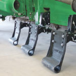 The G4 May Wes Stalk Stomper is a 12-inch wide plate made of half-inch thick UHMW poly, mounted in front of the combine tire to prevent tire damage. | Ron Lyseng photo