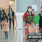 Travellers wearing face masks arrive at the Beijing Capital International Airport Feb. 2 as China copes with an outbreak of the new coronavirus. | Reuters photo