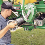 Ben Field installs an IntelligentAg section control unit on a John Deere ground drive 1910 cart. | IntelligentAg photo