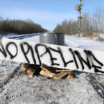 A sign lies on train tracks as supporters of the indigenous Wet'suwet'en Nation's hereditary chiefs camp at a railway blockade as part of protests against British Columbia's Coastal GasLink pipeline, in Edmonton, Alberta, Canada Feb. 19, 2020. REUTERS/Codie McLachlan