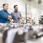 Michael Taschuk, Ph.D., P. Eng, chief technology officer and founder of G2V, with Ryan Tucker, chief executive officer, talk at the G2V production facility. | G2V Optics photo